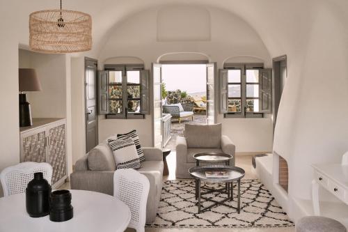 a living room with chairs and a table at Vedema, a Luxury Collection Resort, Santorini in Megalokhori