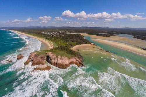 an aerial view of a beach and the ocean at Lens Retreat in Arrawarra