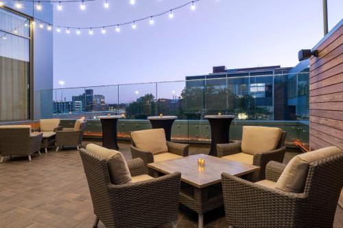 a patio with tables and chairs and a view of a city at The Westin Milwaukee in Milwaukee