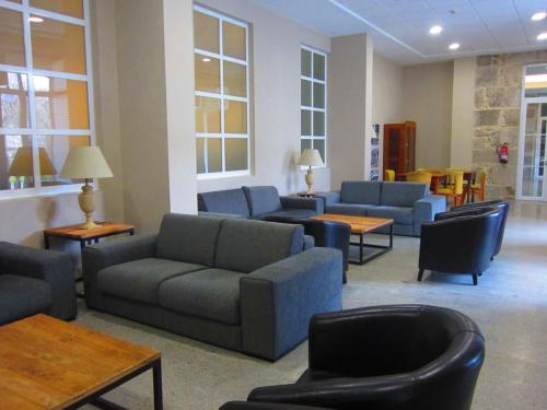 a living room with couches and chairs and tables at Apartamento Paraíso del Agua in Mondariz-Balneario