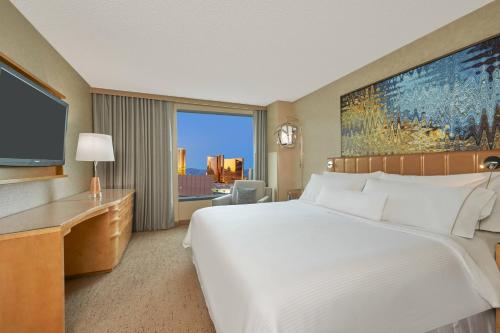 a hotel room with a large bed and a television at The Westin Las Vegas Hotel & Spa in Las Vegas