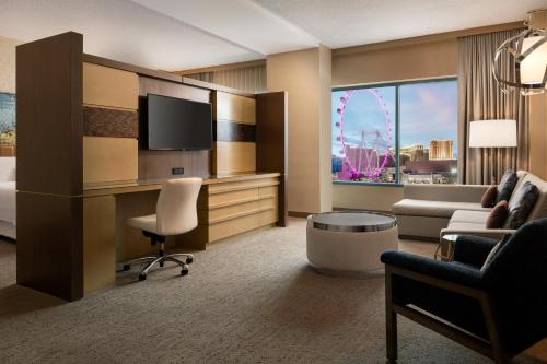 a hotel room with a bed and a desk with a tv at The Westin Las Vegas Hotel & Spa in Las Vegas