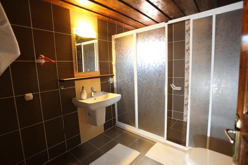 a bathroom with a sink and a shower at Akropolis Guest House in Bergama