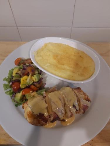 a plate with a plate of food with a bowl of sauce at Hotel Casa Barlovento, Parque Tayrona in Los Naranjos
