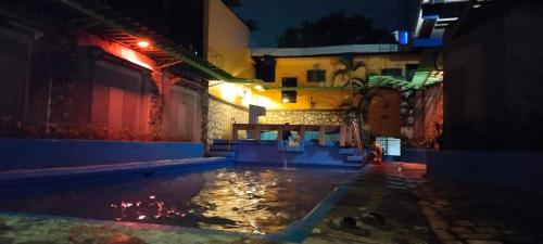 a pool of water in an alley at night at 2 Hotel Saleh in Angeles
