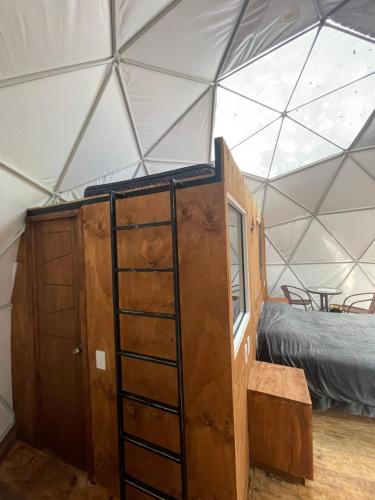 a bedroom in a dome tent with a bed at MANDALA CAMP in Tomatlán