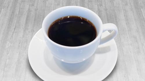 a cup of coffee on a plate on a table at Onoya Hotel in Tagajo