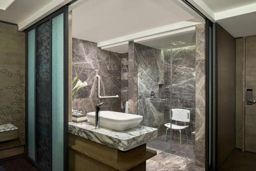 a bathroom with a sink and a shower at Yogyakarta Marriott Hotel in Yogyakarta