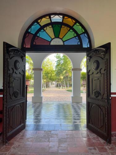 an open door with a stained glass window behind it at Hacienda Kaan Ac in Valladolid