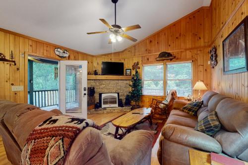 a living room with a couch and a fireplace at The Hydeaway in Hiawassee