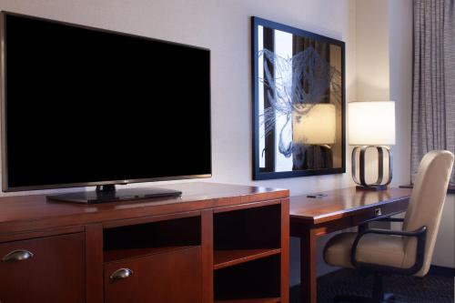 a television on a desk in a hotel room at Sheraton Anchorage Hotel in Anchorage