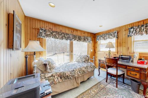 a bedroom with a bed and a desk and a desk at The Pond of West Tisbury in West Tisbury