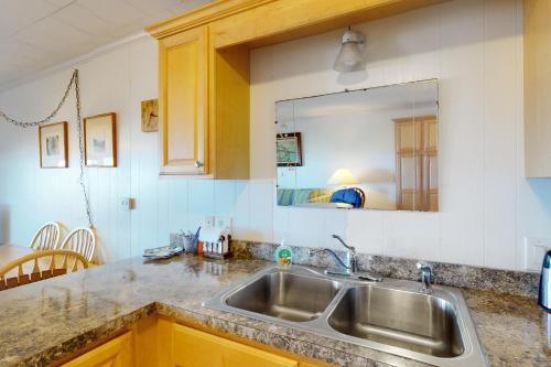 a kitchen counter with a sink and a mirror at Windbreaker 5 in Ocean City