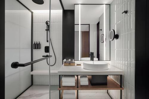 a bathroom with a sink and a shower at Sheraton Chengdu Lido Hotel in Chengdu