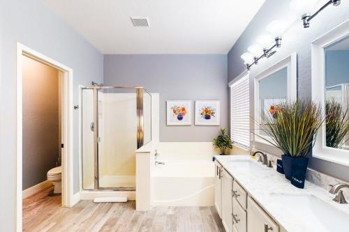 a bathroom with a shower and a sink and a toilet at Riviera Retreat in Sun Lakes