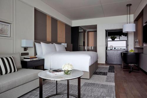 a hotel room with a bed and a couch at The Shanhaitian Resort Sanya, Autograph Collection in Sanya