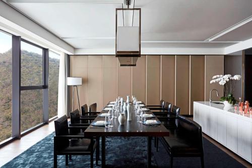 a dining room with a long table and chairs at The Shanhaitian Resort Sanya, Autograph Collection in Sanya