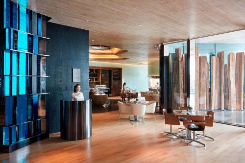 a woman standing in a room with a living room at The Shanhaitian Resort Sanya, Autograph Collection in Sanya