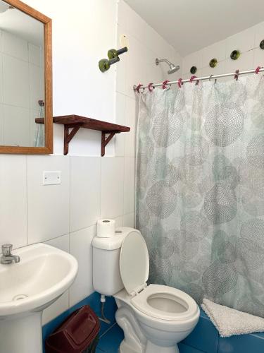 a bathroom with a toilet and a sink at Homestay Pachamama in Cabanaconde