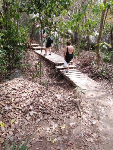 two women walking on a wooden bridge in the woods at Sierra Tayrona hostel in El Zaino