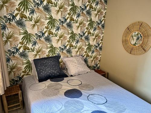 a bedroom with a bed with a wall with palm trees at Oostende City Center Yellow in Ostend