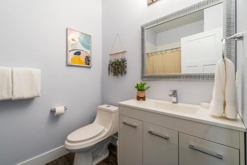 a bathroom with a toilet and a sink and a mirror at Heaven's Haven in Vernon