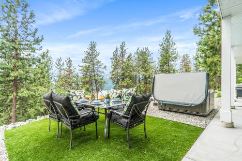 a patio with a table and chairs and a large screen at Heaven's Haven in Vernon