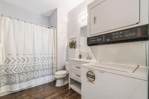 a white bathroom with a toilet and a sink at Heaven's Haven in Vernon