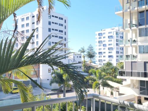 a view from the balcony of a building with palm trees at Mooloolaba Beach Club Paradise 2 Bedroom Apartment in Mooloolaba