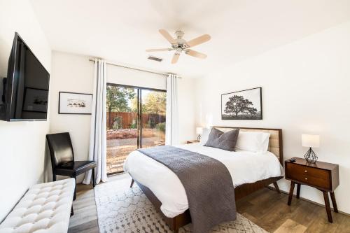 a white bedroom with a bed and a window at WEST SEDONA RETREAT w/ VIEWS of Coffee Pot Rock! in Sedona