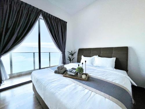a bedroom with a large bed with a large window at SilverScape l A4011 l Luxury 3BR l Bathtub l 6-11 pax l Seaview l Infinity Pool l Jonker Street l City Centre by Jay Stay in Melaka