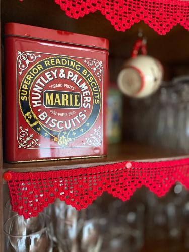 a container of marmite on a red shelf at A casa das minhas netas in Caldas da Rainha