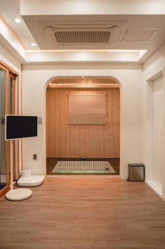 a large room with a projection screen on the wall at Gyeong-ju Stayangim in Gyeongju