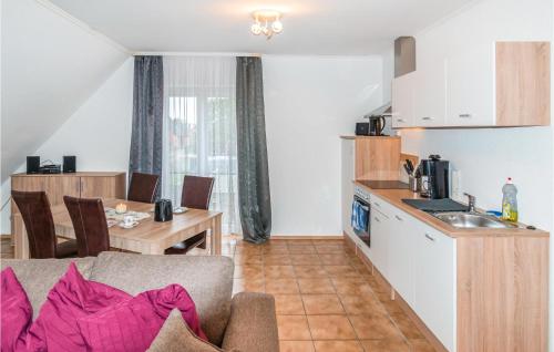 a kitchen and living room with a couch and a table at Cozy Apartment In Harrislee With Wifi in Harrislee