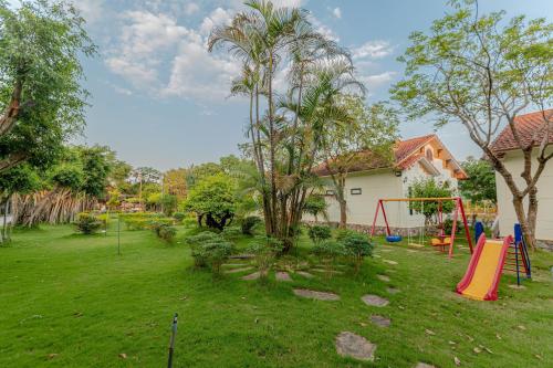 a yard with a swing set and a playground at Hoa Lu Garden Resort in Ninh Binh