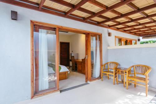 a room with a table and chairs and a bedroom at Dinar Hills Ungasan in Nusa Dua