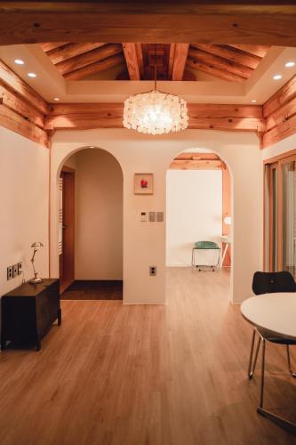 a large room with wooden ceilings and a chandelier at Gyeong-ju Stayangim in Gyeongju