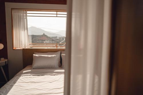 a bedroom with a bed in front of a window at StayAnGim in Gyeongju