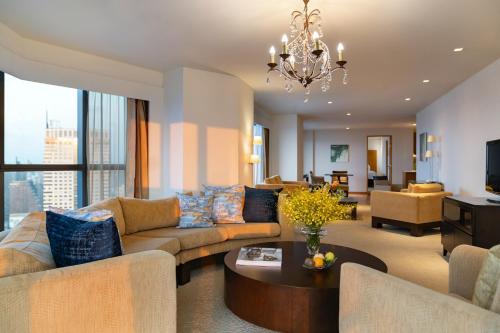 曼谷的住宿－Tower Club at lebua，客厅配有沙发和桌子