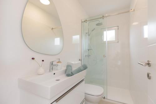 a white bathroom with a sink and a shower at NEW!!! Luminose beach house in Pakoštane