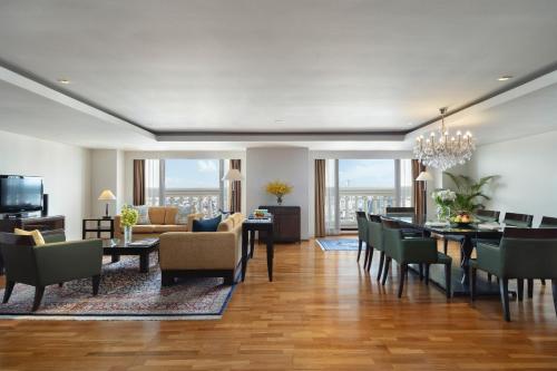 a dining room and living room with a table and chairs at Tower Club at lebua in Bangkok