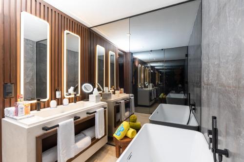 a bathroom with two sinks and a large mirror at Grand Palladium Kantenah Resort & Spa - All Inclusive in Akumal