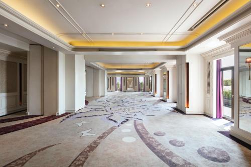 a hallway in a building with a large carpeted floor at Tower Club at lebua in Bangkok