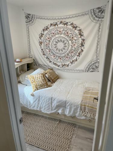 a bedroom with a bed with a mandala on the wall at Casa Di Nonna in Wasaga Beach