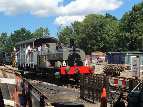 an old train on the tracks with people on it at Whitwell and Reepham Station - Meadow View in Norwich