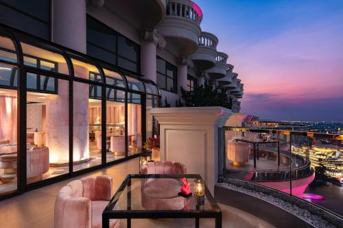 a balcony of a building with chairs and a table at Tower Club at lebua in Bangkok