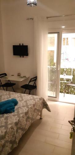 a bedroom with a bed and a table with chairs at Luxury apartment 3 rooms near metro in Athens