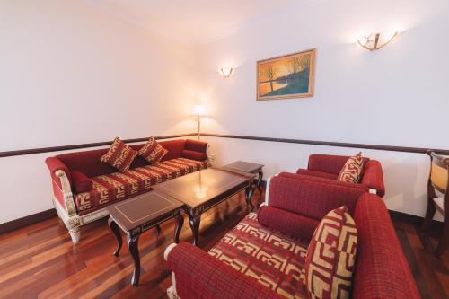 a living room with two couches and a coffee table at Saigon Dalat Hotel in Da Lat