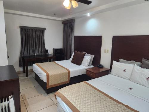 墨西卡利的住宿－Hotel Don Quijote，酒店客房配有两张床和一张书桌