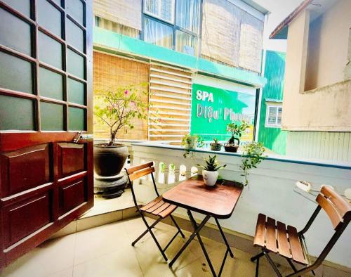 a table and chairs in front of a window at EVA Hotel in Hue
